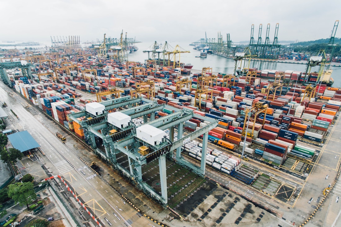 Container ship moving cargo through an international port